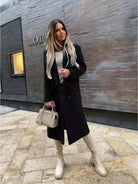 Ein-langer-eleganter-Mantel-mit-Klappkragen-und-doppelt-geknöpfter-Vorderseite,-ideal-für-einen-stilvollen-Herbst-oder-Winterlook.