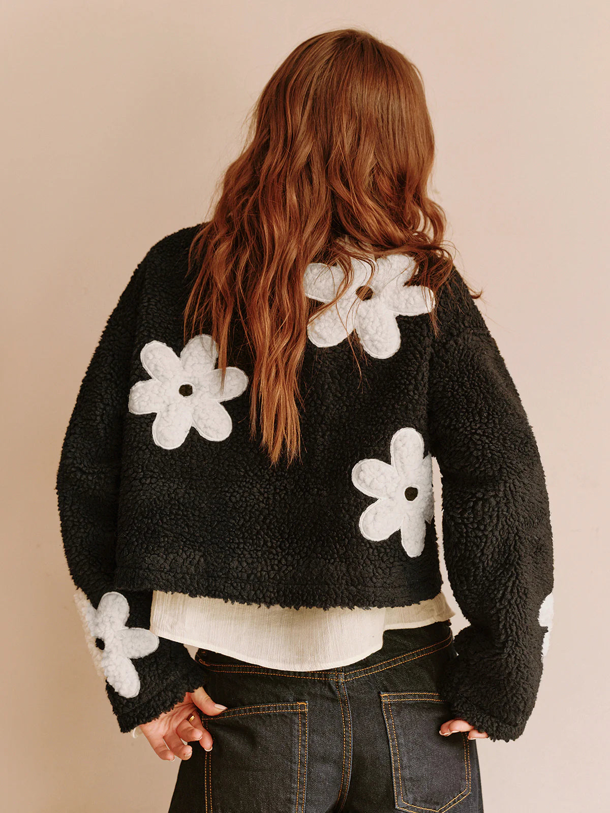 Blumenmuster–Fleecejacke–schwarz–mit–weißen–Blumen–Reißverschluss–bequem–und–lässig