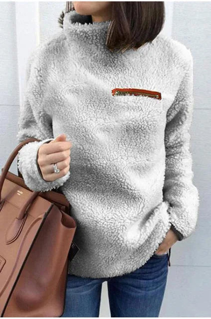 Flauschiger-Pullover-mit-hohem-Kragen-und-reißverschlussähnlichem-Detail,-ideal-für-einen-bequemen-und-warmen-Winterlook.